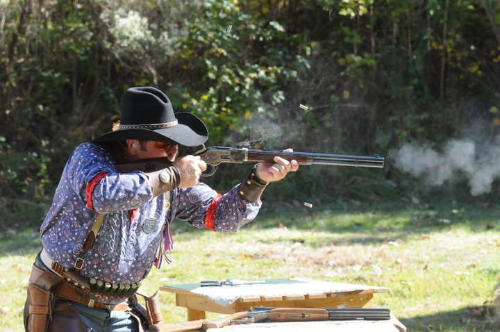 Red River Ray shooting his Cowboy Gunworks 20 inch pistol grip 1873 and a pair of 5.5 inch Ruger New Vaqueros.  Both his rifle and pistols have FULL RACE Action Jobs.' width=